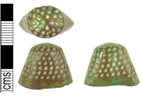 Cast cu-alloy thimble with individually drilled holes dating from the late medieval period.